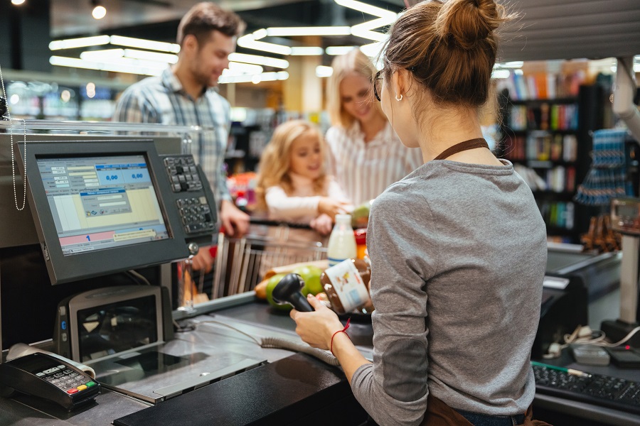 a cashier scanning products at grocery store