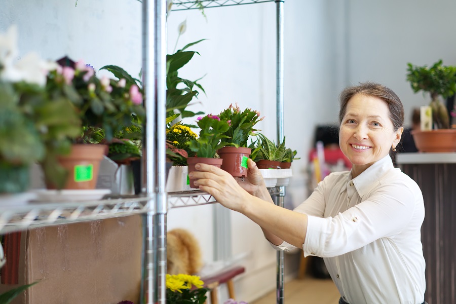 a lady working at a plants and flowers shop